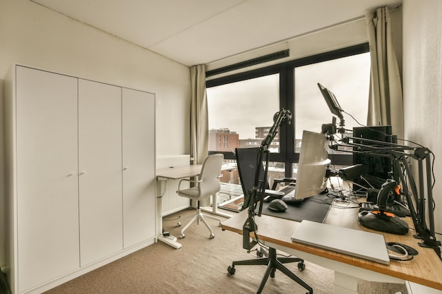 Room with a desk with a window and a view