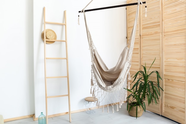 Room with hammock and white walls