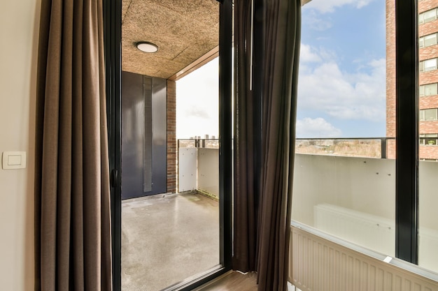 A room with a large window and a balcony