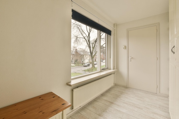 A room with a large window and a wooden table