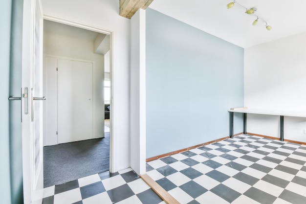 Room with soft blue walls and a checkerboard floor