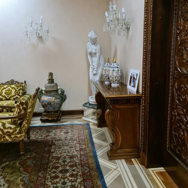 A room with a statue and a rug