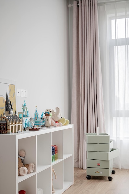 a room with a view of the window and a painting of a city