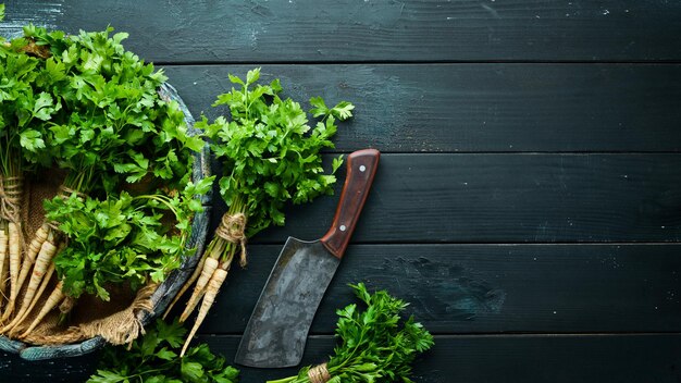 Root parsley on a wooden background Top view Free space for your text