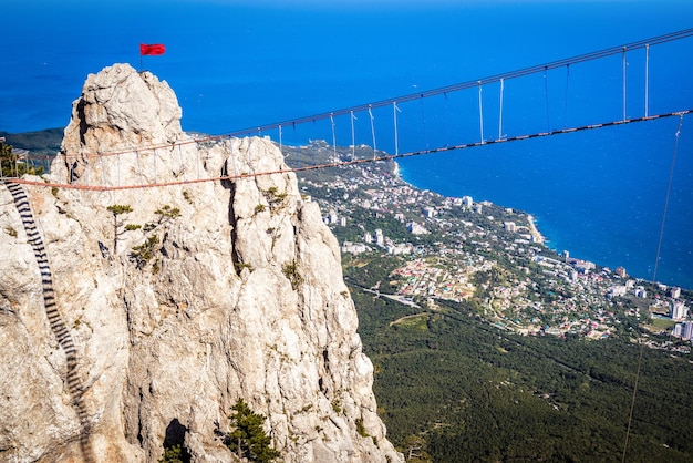 Rope bridge above chasm on Mount AiPetri overlooking Black Sea coast Crimea