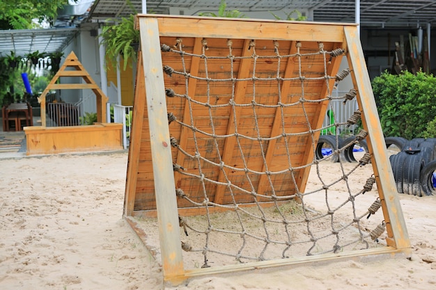 Rope net tied for climb. Outdoor playground.