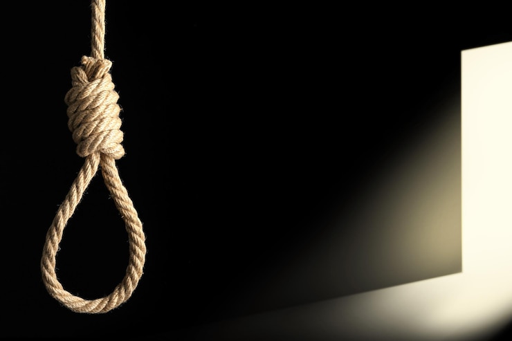 Photo rope noose in darkness and doorway with light