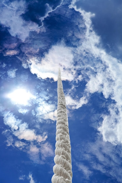 Rope rises to clouds in dark sky