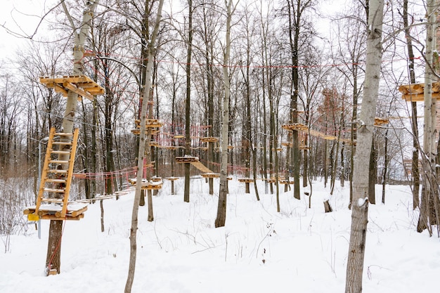 Rope town. Rope road suspended from trees and logs. Winter landscape. Creative idea.