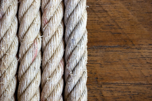 Rope vintage on brown wood background. Closeup and copy space.