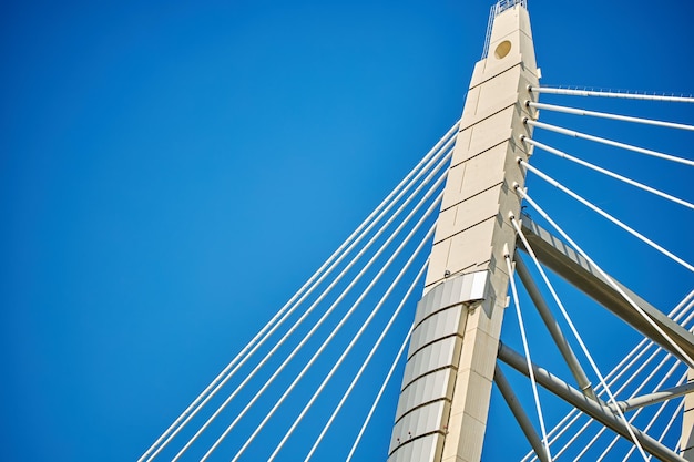 Ropes of a cablestayed bridge against a blue sky