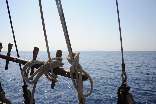 写真 空の向こうの海で帆船の木に縛られたロープ