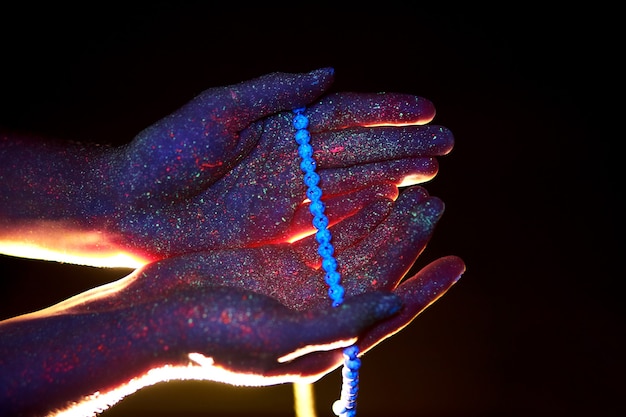 Rosary in hand, prayer. light through the palms of your hands
in ultraviolet, god and religion, beads. divine light through your
fingers, prophet muhammad