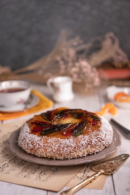 Rosca de reyes king cake glazed fruit Provencal Galette des rois on a wooden table