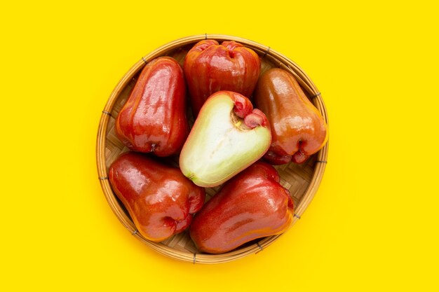 Rose apple in bamboo basket on white background