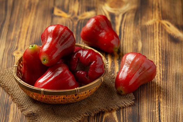 Rose apple on dark wooden surface