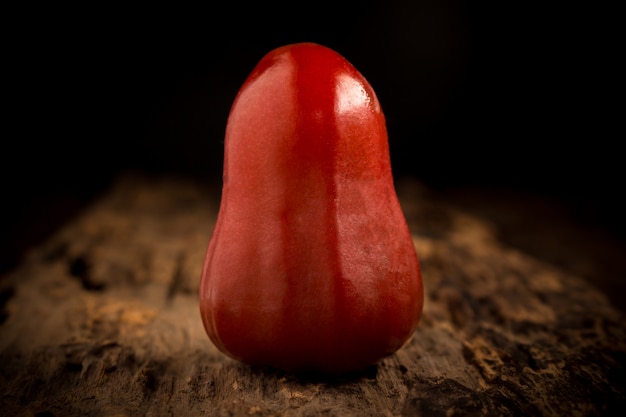 Rose apple on wood. dark. night