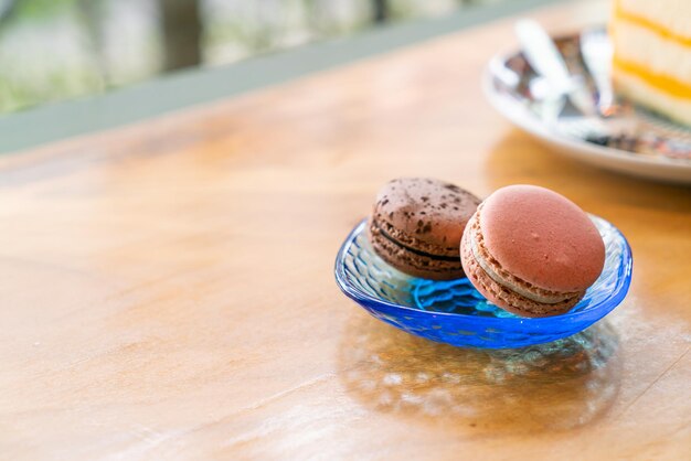 Rose and chocolate macaron on plate