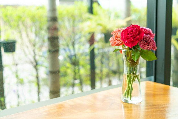 Rose flower in vase decoration on wood bar