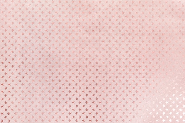 Rose gold background from metal foil paper with a stars pattern