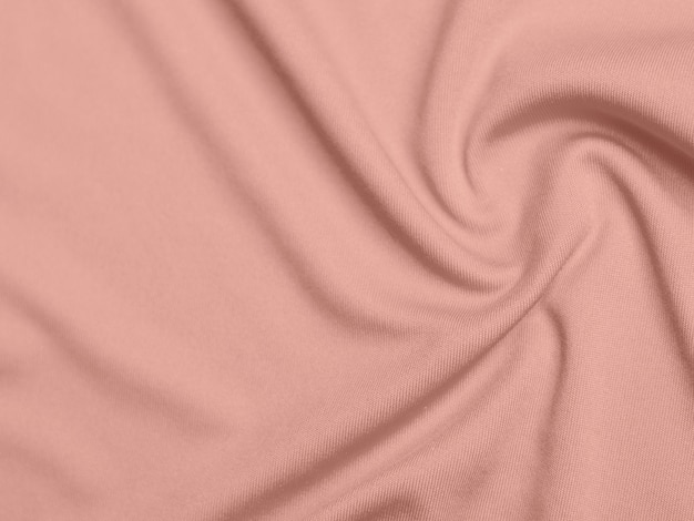 Rose goud kleur fluwelen stof textuur gebruikt als achtergrond lege roze gouden stof achtergrond van zacht en glad textielmateriaal er is ruimte voor tekst