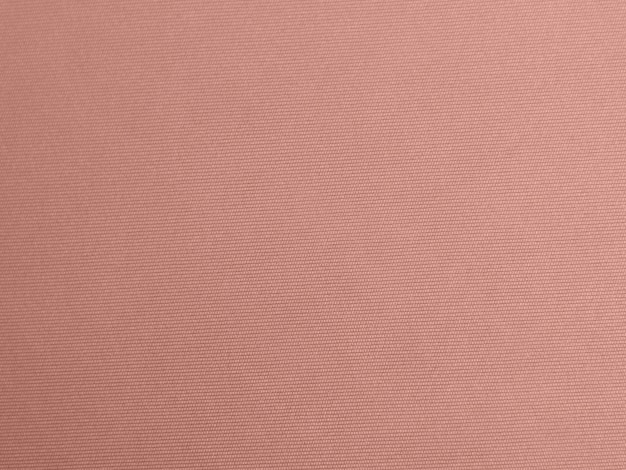 Rose goud kleur fluwelen stof textuur gebruikt als achtergrond Lege roze gouden stof achtergrond van zacht en glad textielmateriaal Er is ruimte voor tekst