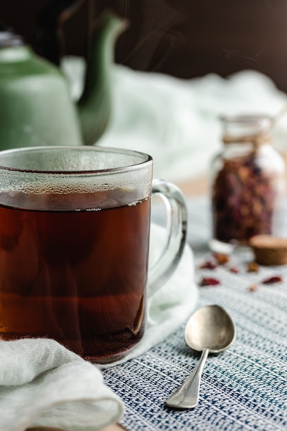 Rose and herbal tea in a small glass bottle