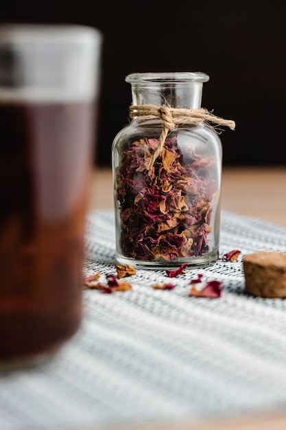 Rose and herbal tea in a small glass bottle