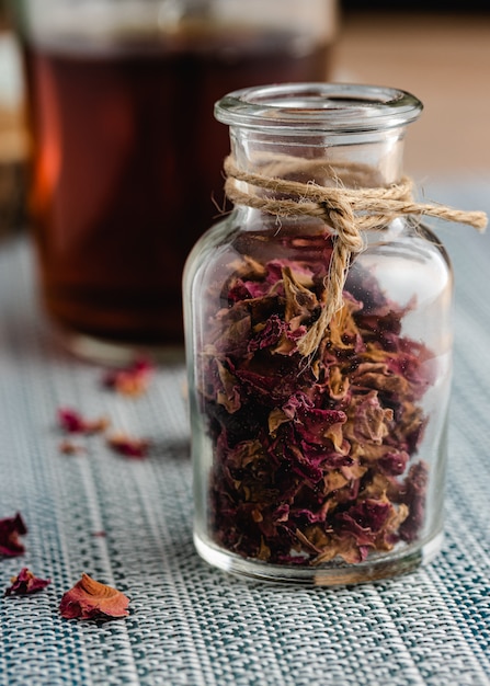 Rose and herbal tea in a small glass bottle