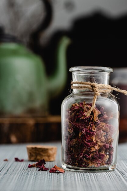 Rose and herbal tea in a small glass bottle