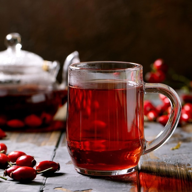 Rose hip berries herbal tea in glass teapot