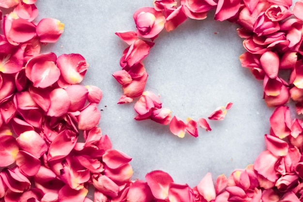 Rose petals on marble stone floral background