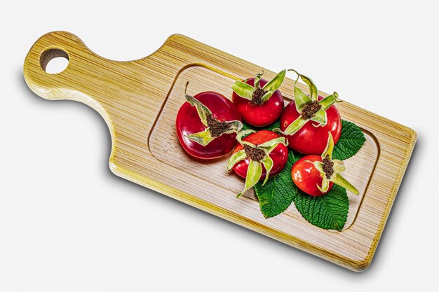 Rosehip berries on a wooden bamboo board. Natural natural vitamins. Ingredients for tea. Medicine and health.