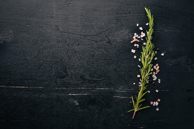 Rosemary and spices On a wooden background Free space for your text Top view