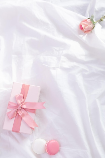 Roses and gift boxes on the white tablecloth