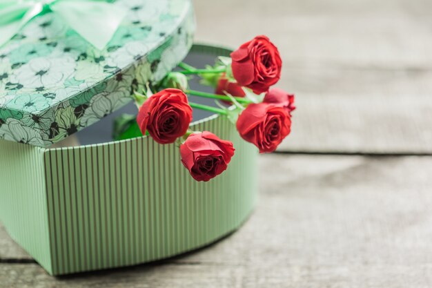 Roses and a hearts on wooden board