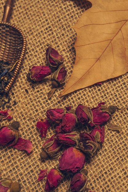 Photo roses for making tea on a cheesecloth with autumn leaves