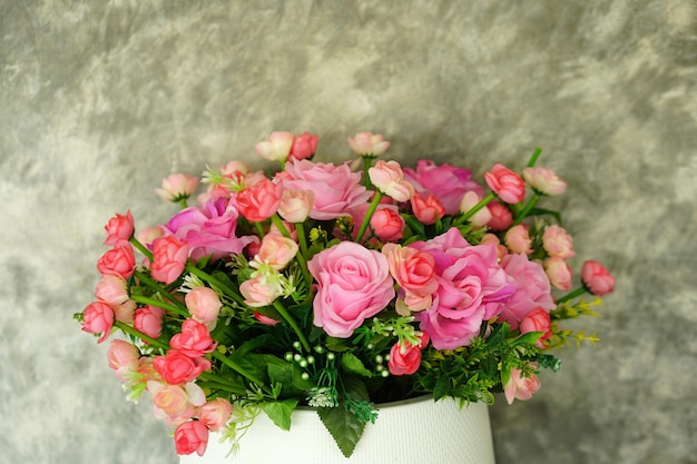 Roses in pots cement wall background