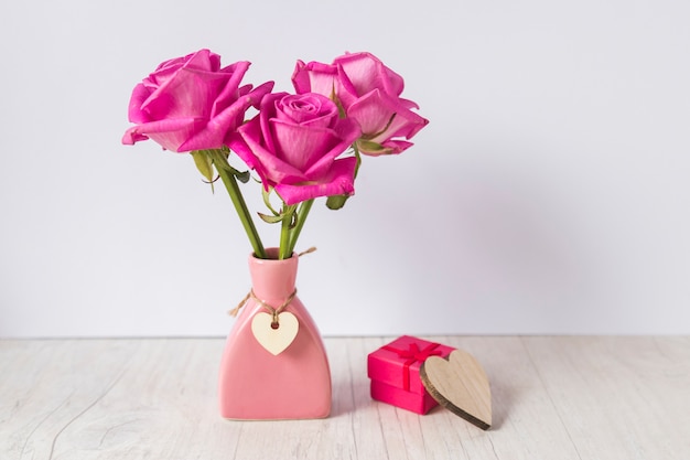 Photo roses in vase with gift box on light table