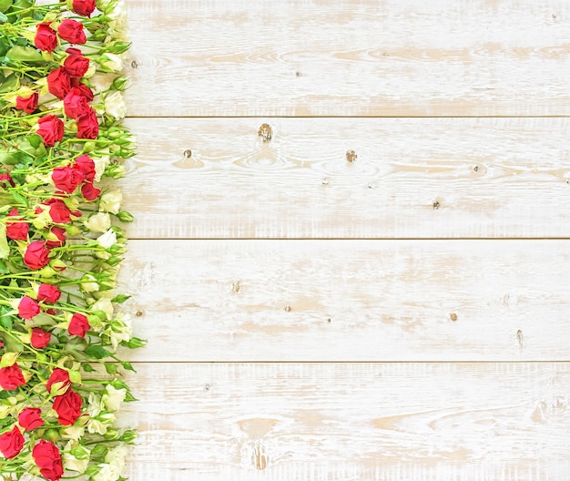 Roses on a wooden background. Spring flowers.