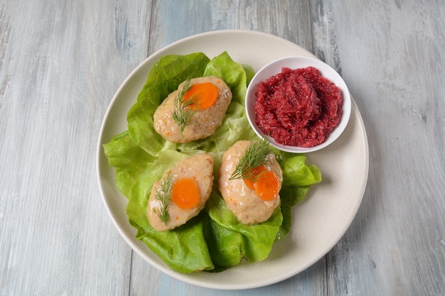 Rosh Hashana table setting. Traditional Jewish Passover food- gefilte fish with carrots, lettuce and horseradish.