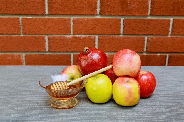 Rosh hashanah jewesh holiday concept honey apple and pomegranate