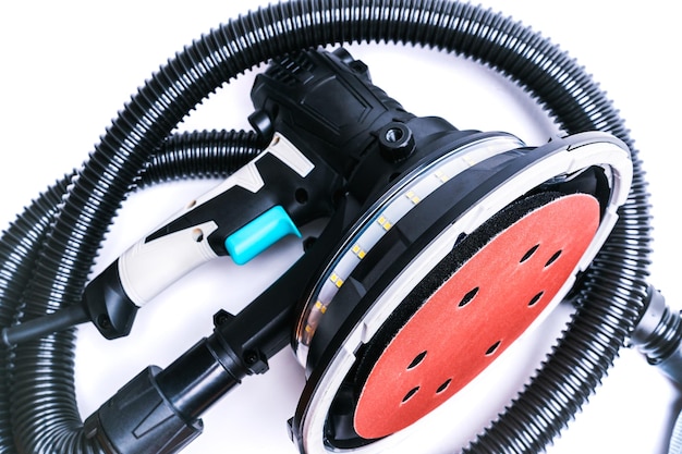 Rotary grinder with LED light and vacuum cleaner hose isolate on white background