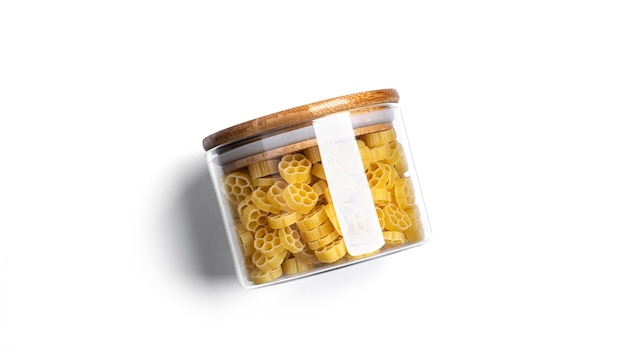 Rotelle pasta in glass jar isolated.