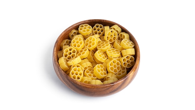 Rotelle pasta in wooden bowl isolated on white background. High quality photo