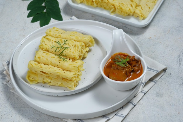 Roti Jala or lace pancake or net crepe served with lamb or mutton curry