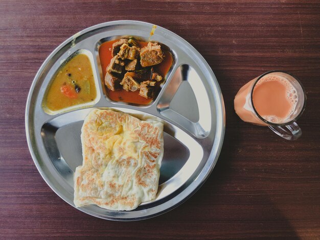 Roti Prata or Roti Canai with Teh tarik Very famous food and drink in Malaysia