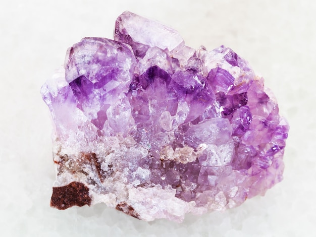 Rough Amethyst crystal druse on white marble