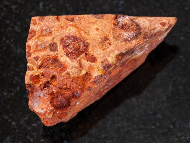 Rough bauxite ore on dark background