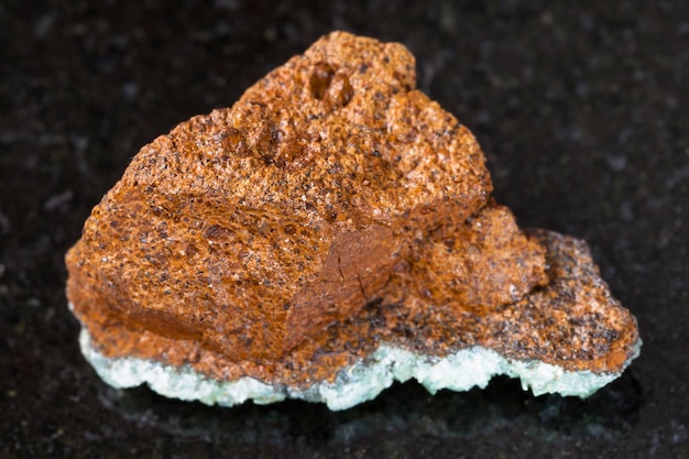 Rough bog iron ore limonite stone on dark